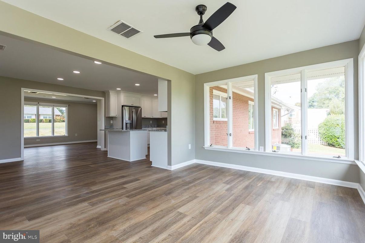 Empty room, Interior, Kitchen, Recessed Lighting, Stainless Steel Appliances, Wood Texture Flooring