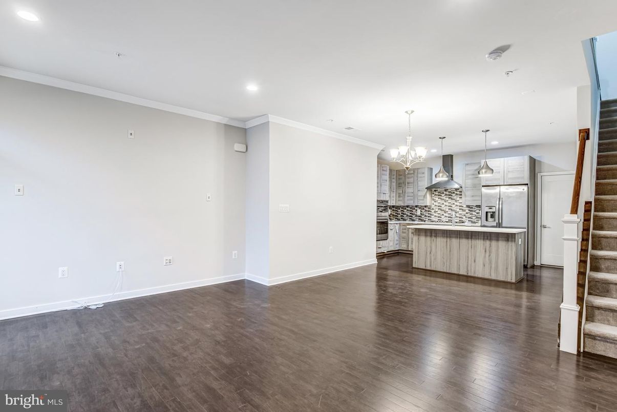 Chandelier, Empty room, Interior, Kitchen, Pendant Lights, Recessed Lighting, Stainless Steel Appliances, Wood Texture Flooring