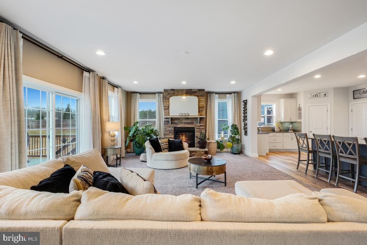 Dining room, Fireplace, Interior, Living room, Recessed Lighting, Stone Walls, Wood Texture Flooring
