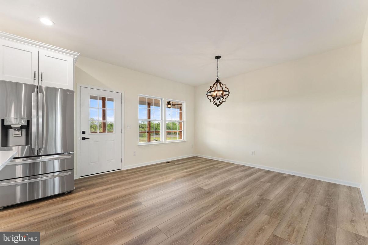 Empty room, Interior, Kitchen, Pendant Lights, Recessed Lighting, Stainless Steel Appliances, Wood Texture Flooring