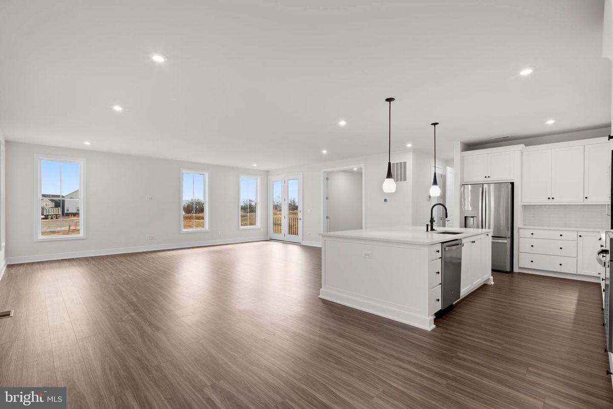 Empty room, Interior, Kitchen, Pendant Lights, Recessed Lighting, Stainless Steel Appliances, Wood Texture Flooring