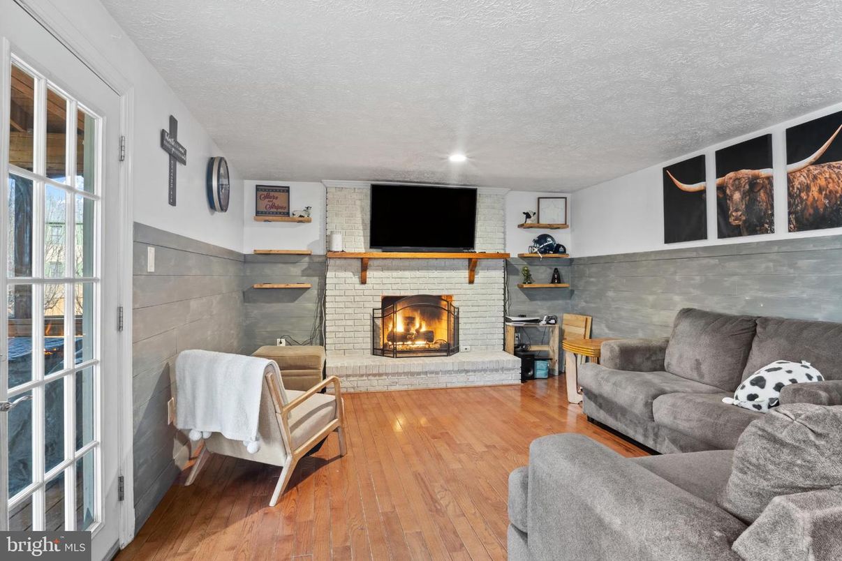 Fireplace, Interior, Living room, Recessed Lighting, Stone Walls, Wood Texture Flooring