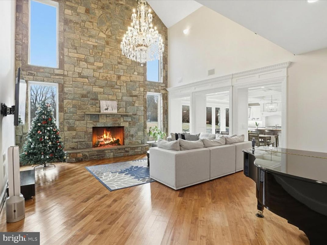 Chandelier, Fireplace, Interior, Living room, Piano, Recessed Lighting, Stone Walls, Wood Texture Flooring