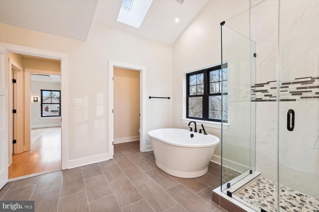 Bathroom, Free Standing Baths, Glass Shower, Interior, Marble Walls, Recessed Lighting, Wood Texture Flooring