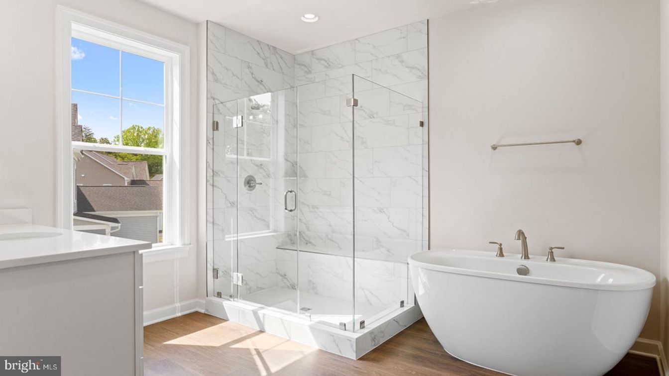 Bathroom, Free Standing Baths, Glass Shower, Interior, Marble Walls, Recessed Lighting, Wood Texture Flooring