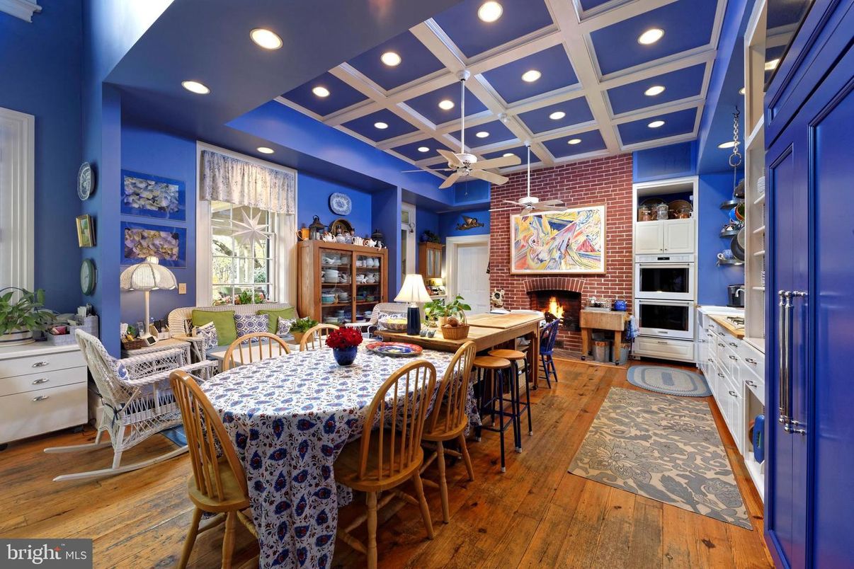 Dining room, Fireplace, Interior, Kitchen, Recessed Lighting, Stainless Steel Appliances, Stone Walls, Wood Texture Flooring