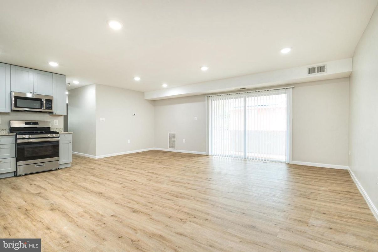 Empty room, Interior, Kitchen, Recessed Lighting, Stainless Steel Appliances, Wood Texture Flooring