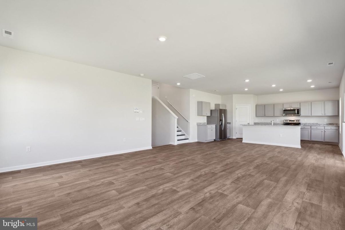 Empty room, Interior, Kitchen, Recessed Lighting, Stainless Steel Appliances, Wood Texture Flooring