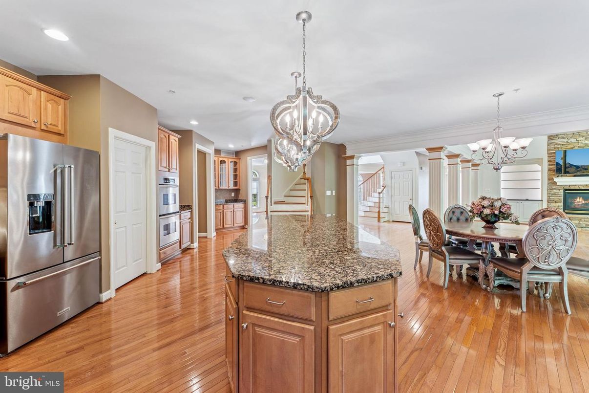 Chandelier, Dining room, Fireplace, Interior, Kitchen, Pendant Lights, Recessed Lighting, Stainless Steel Appliances, Wood Texture Flooring