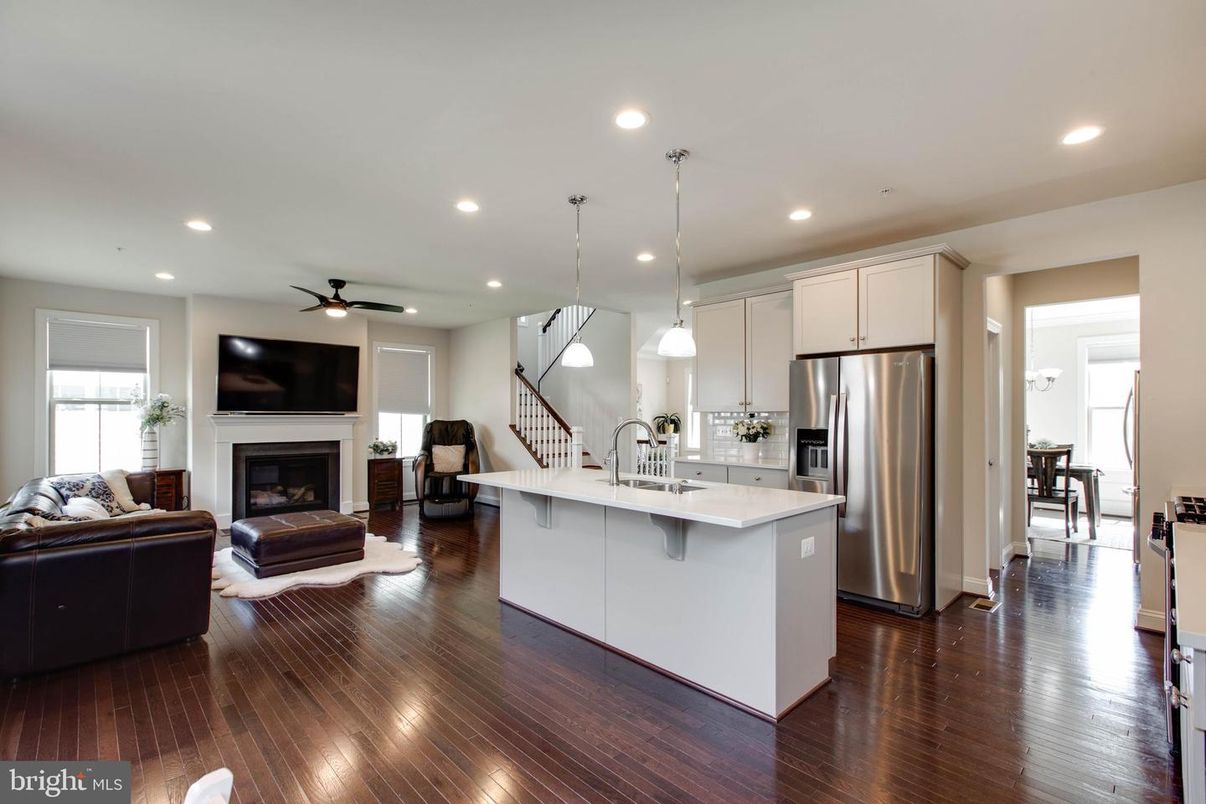 Fireplace, Interior, Kitchen, Living room, Pendant Lights, Recessed Lighting, Stainless Steel Appliances, Wood Texture Flooring