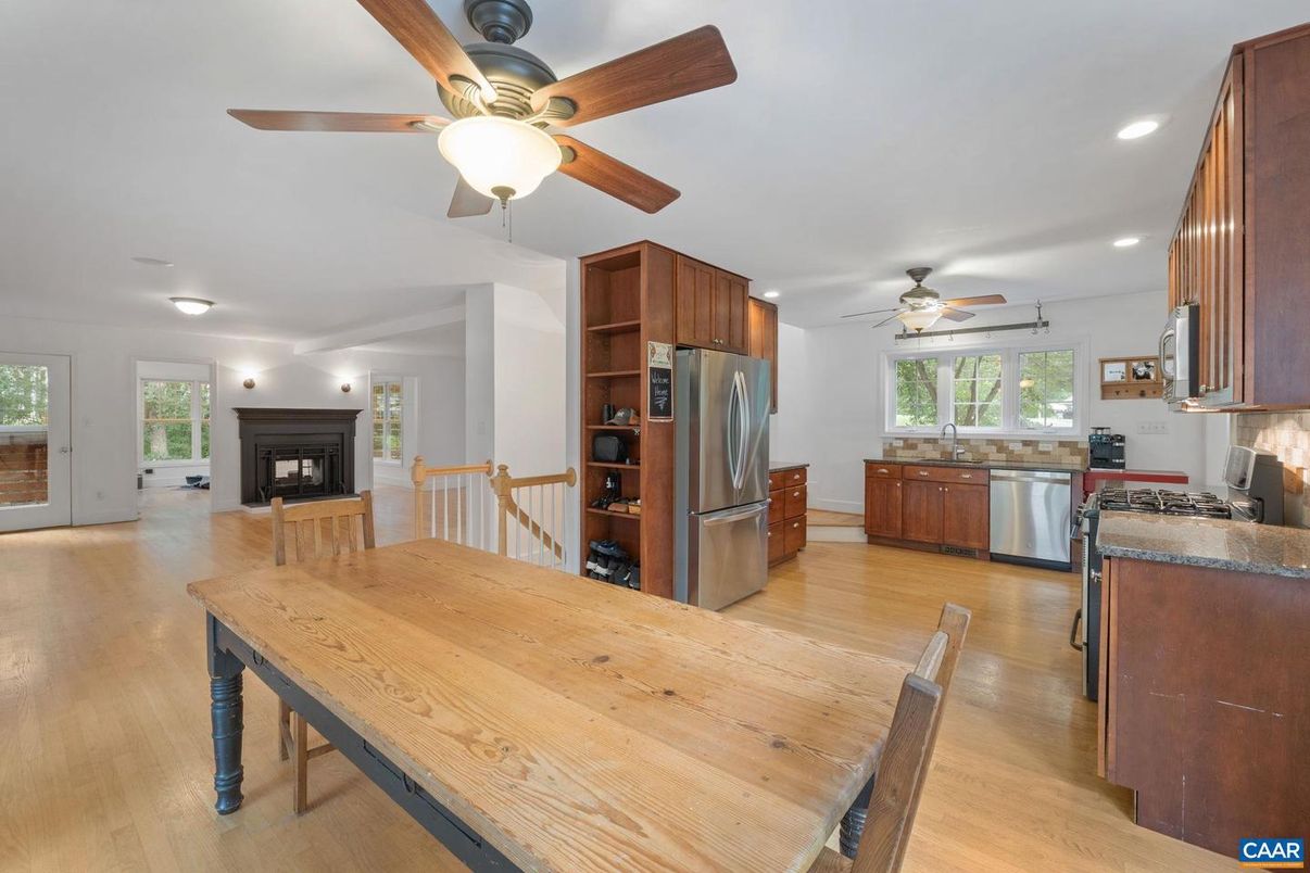 Dining room, Fireplace, Interior, Kitchen, Recessed Lighting, Stainless Steel Appliances, Wood Texture Flooring