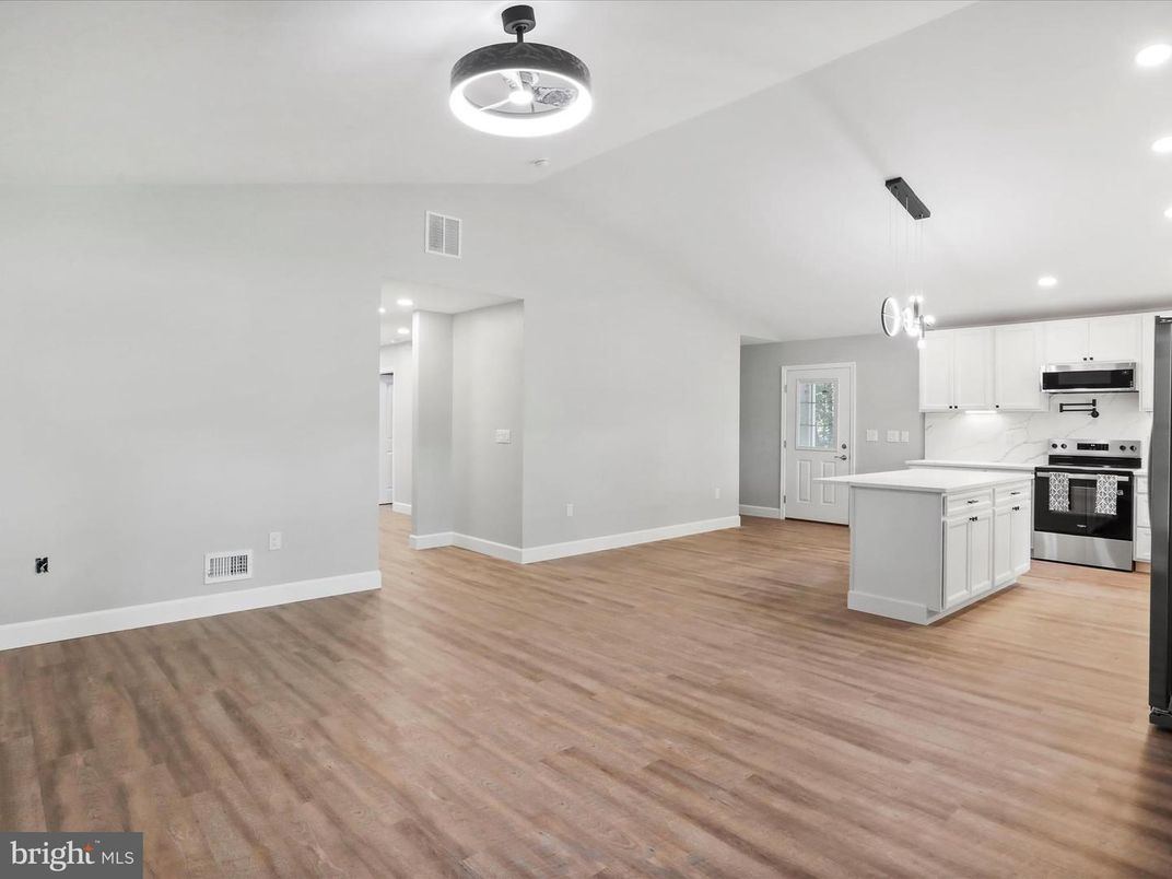 Empty room, Interior, Kitchen, Pendant Lights, Recessed Lighting, Stainless Steel Appliances, Wood Texture Flooring
