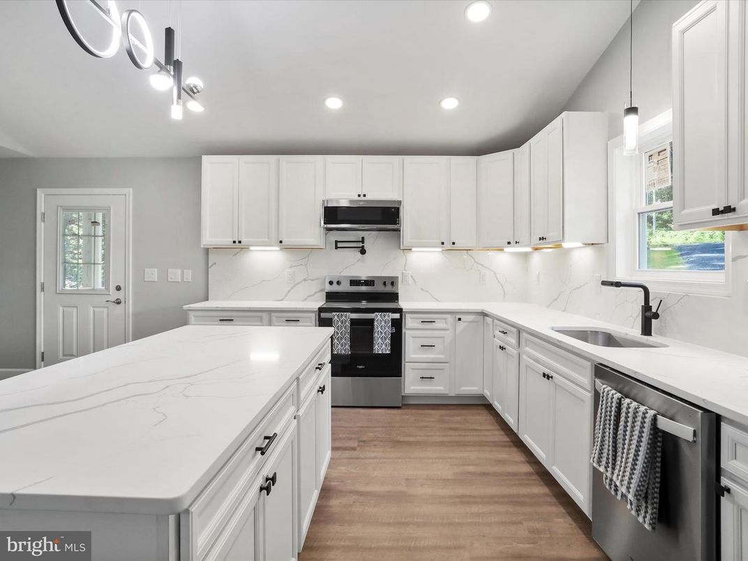 Interior, Kitchen, Marble Walls, Pendant Lights, Recessed Lighting, Stainless Steel Appliances, Wood Texture Flooring