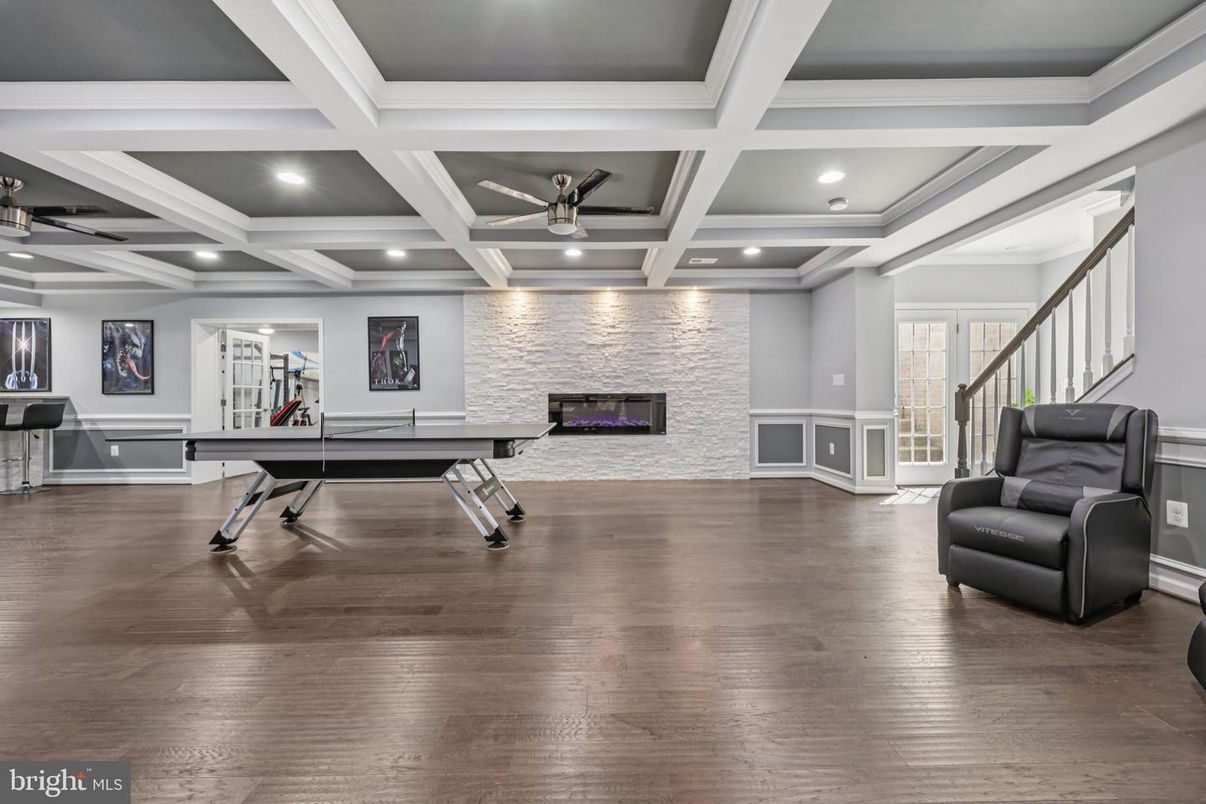 Fireplace, Game Room, Interior, Recessed Lighting, Wood Texture Flooring