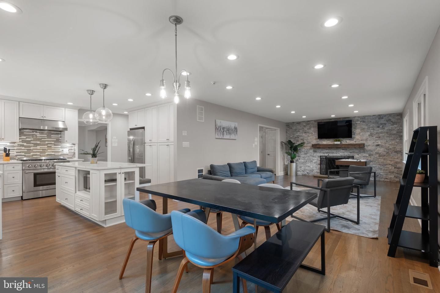 Dining room, Fireplace, Interior, Kitchen, Living room, Pendant Lights, Recessed Lighting, Stainless Steel Appliances, Stone Walls, Wood Texture Flooring