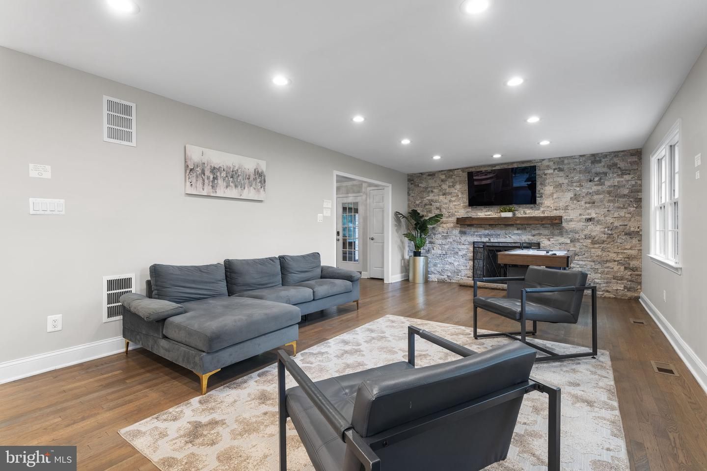 Fireplace, Interior, Living room, Recessed Lighting, Stone Walls, Wood Texture Flooring