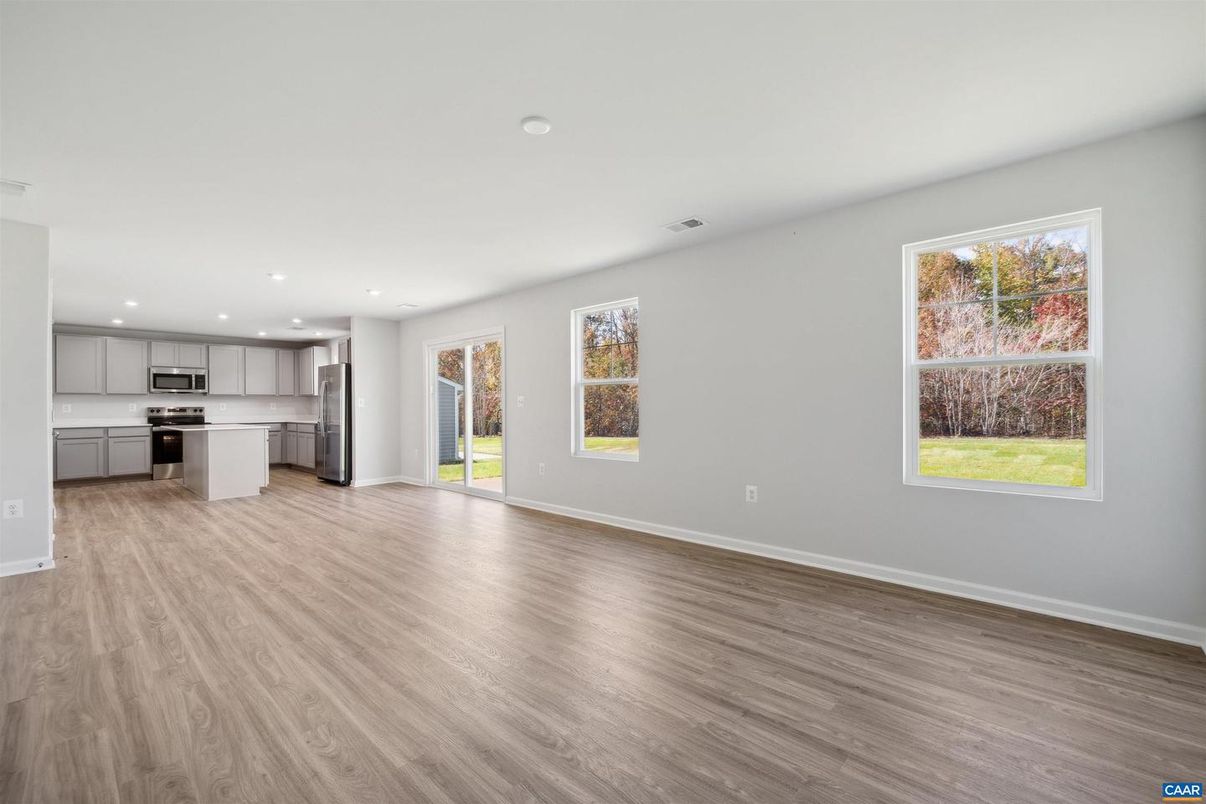 Empty room, Interior, Kitchen, Recessed Lighting, Stainless Steel Appliances, Wood Texture Flooring