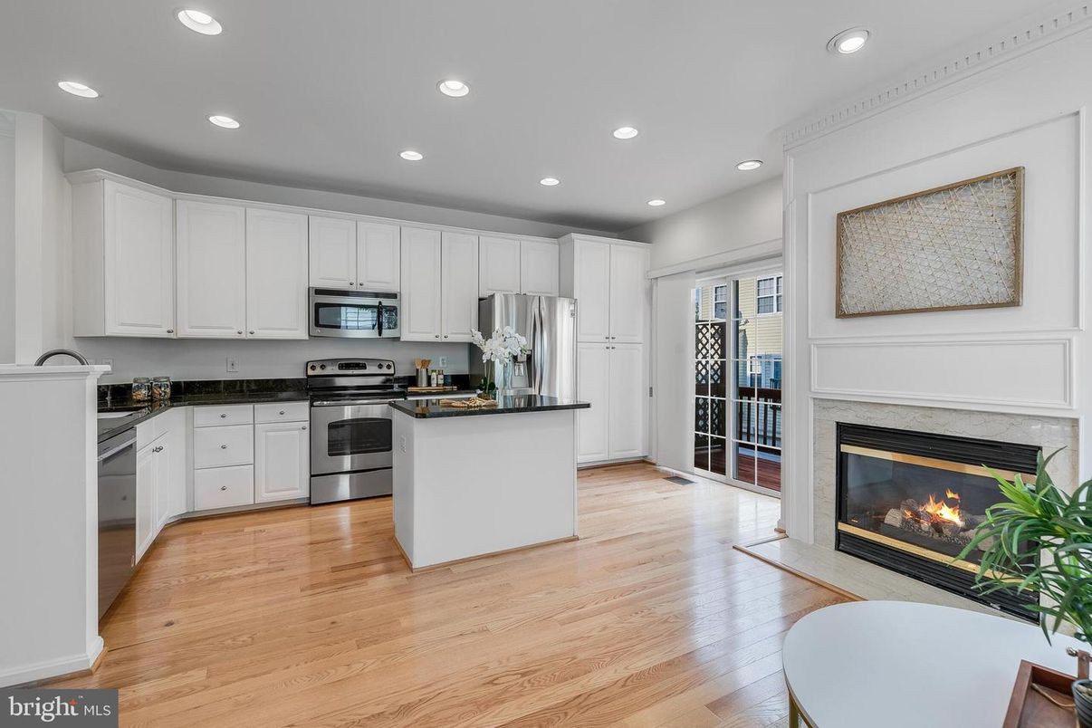 Fireplace, Interior, Kitchen, Recessed Lighting, Stainless Steel Appliances, Wood Texture Flooring