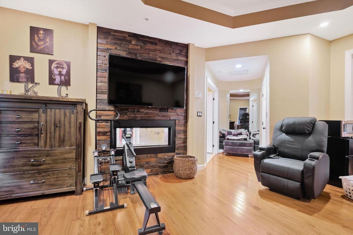 Fireplace, Fitness Equipment, Interior, Recessed Lighting, Stone Walls, Wood Texture Flooring
