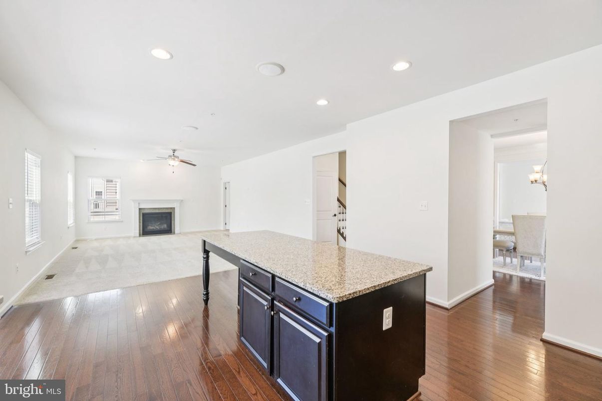 Chandelier, Dining room, Empty room, Fireplace, Interior, Kitchen, Recessed Lighting, Wood Texture Flooring