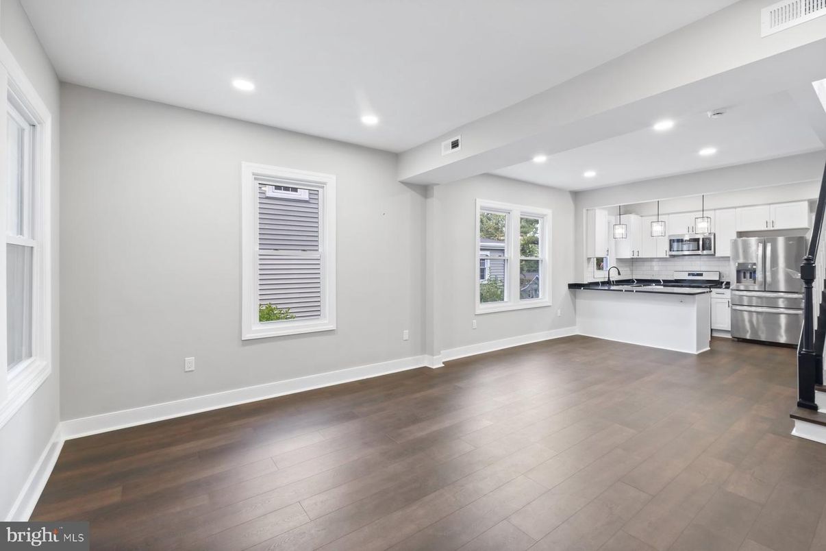 Empty room, Interior, Kitchen, Recessed Lighting, Stainless Steel Appliances, Wood Texture Flooring