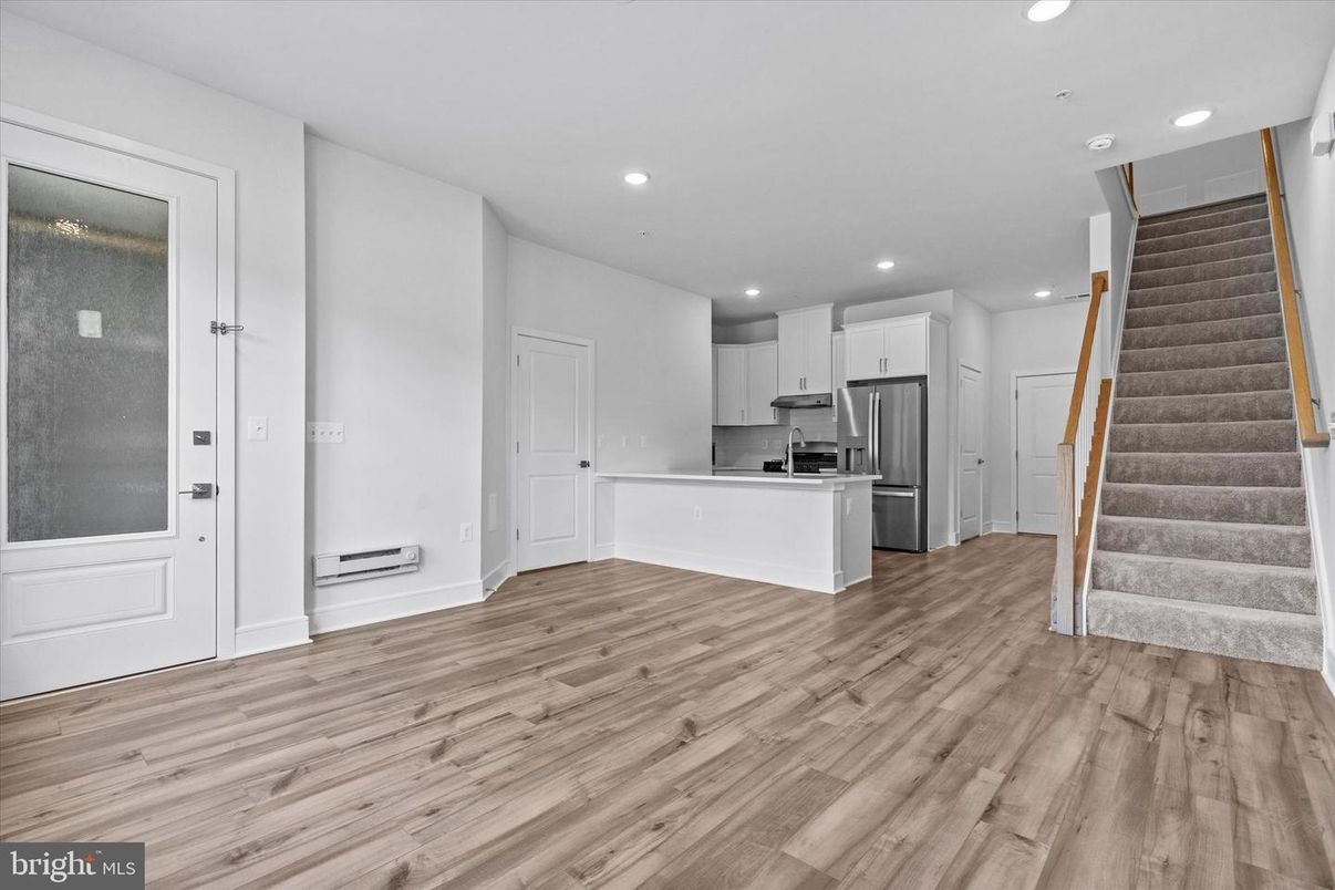 Empty room, Interior, Kitchen, Recessed Lighting, Stainless Steel Appliances, Wood Texture Flooring