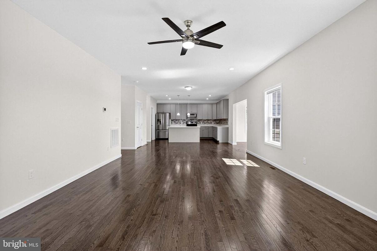 Empty room, Interior, Kitchen, Recessed Lighting, Stainless Steel Appliances, Wood Texture Flooring