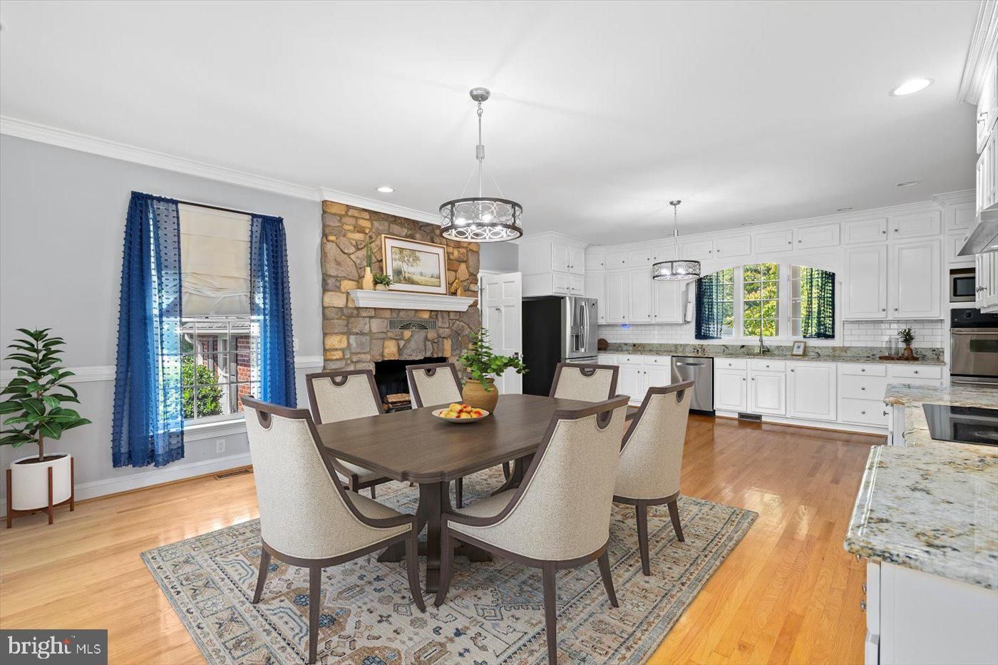 Dining room, Fireplace, Interior, Kitchen, Pendant Lights, Recessed Lighting, Stainless Steel Appliances, Stone Walls, Wood Texture Flooring