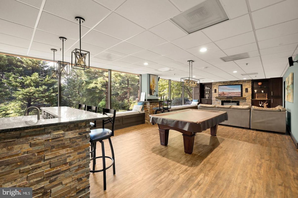 Billiard Table, Fireplace, Game Room, Interior, Living room, Pendant Lights, Recessed Lighting, Stone Walls, Wood Texture Flooring