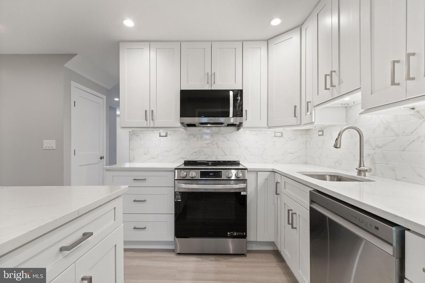 Interior, Kitchen, Marble Walls, Recessed Lighting, Stainless Steel Appliances, Wood Texture Flooring