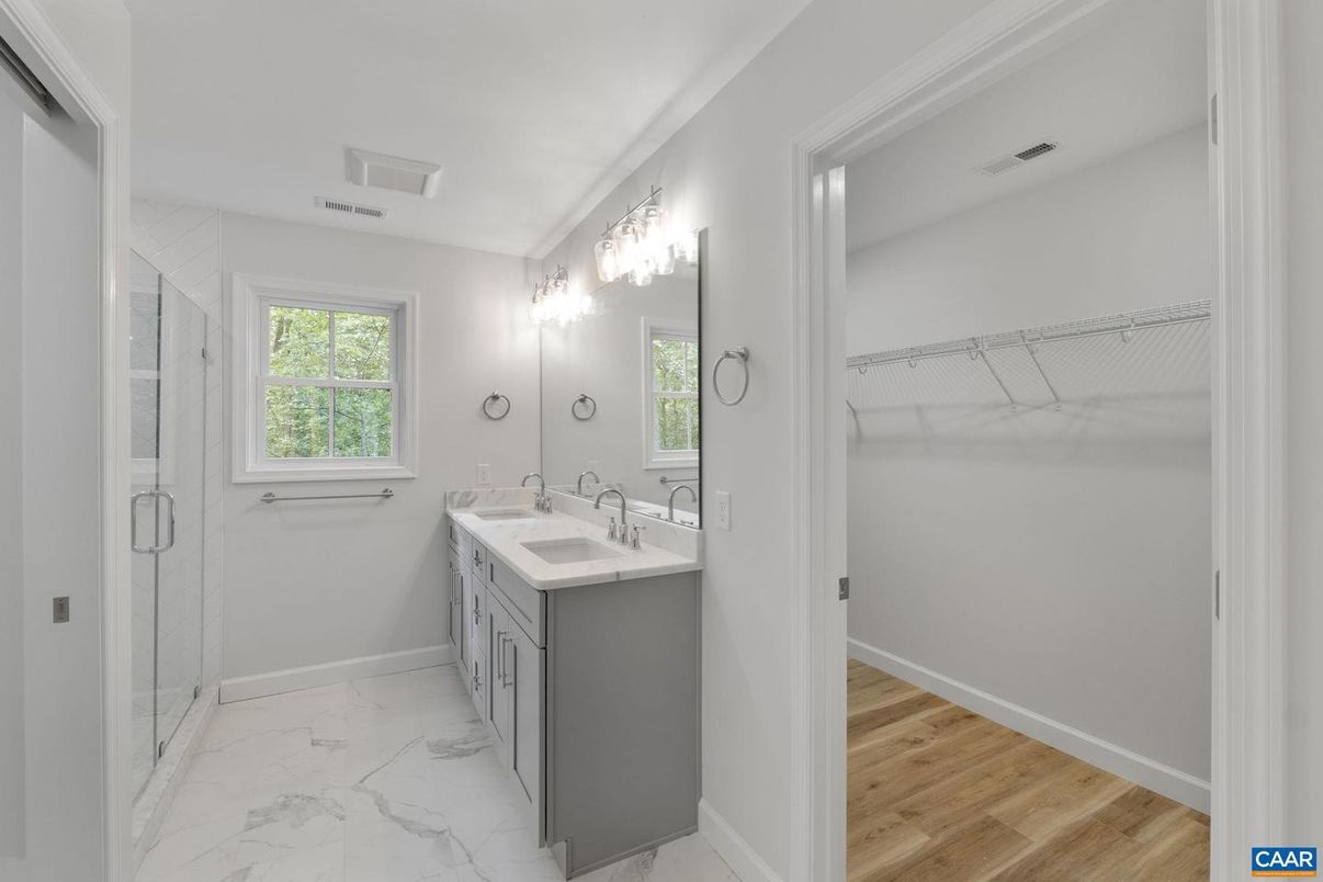 Bathroom, Dual Sink Vanities, Glass Shower, Interior, Marble, Walk-in Closets, Wood Texture Flooring