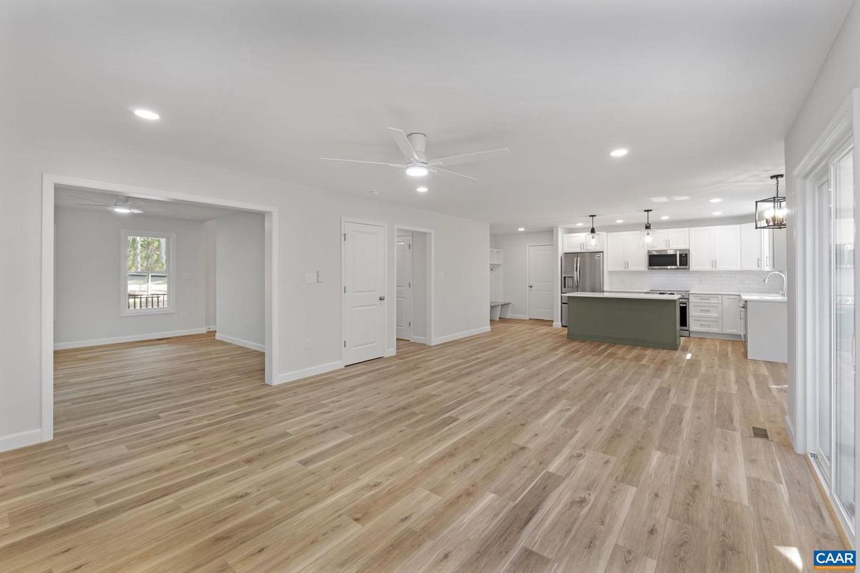 Empty room, Interior, Kitchen, Pendant Lights, Recessed Lighting, Stainless Steel Appliances, Wood Texture Flooring