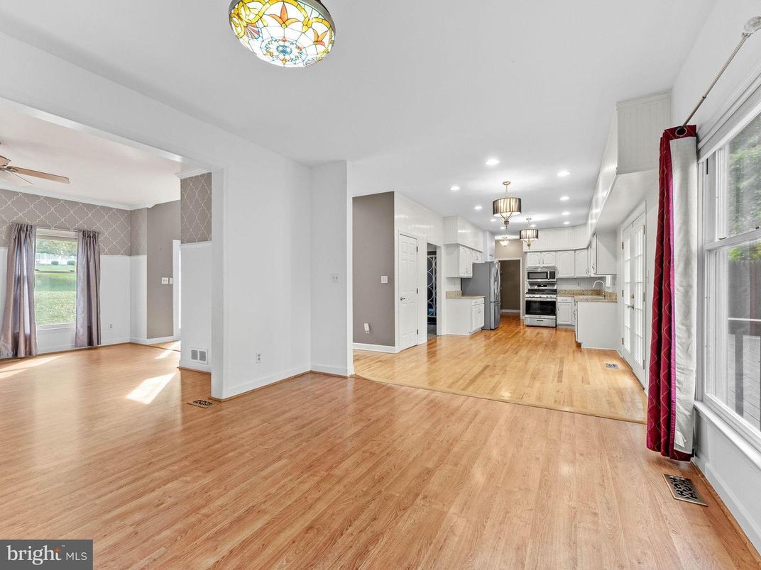 Empty room, Interior, Kitchen, Pendant Lights, Recessed Lighting, Stainless Steel Appliances, Wood Texture Flooring