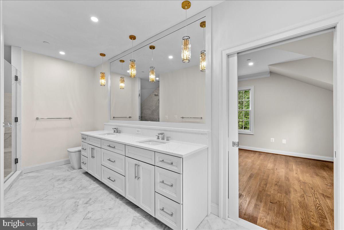 Bathroom, Dual Sink Vanities, Interior, Marble, Pendant Lights, Recessed Lighting, Wood Texture Flooring