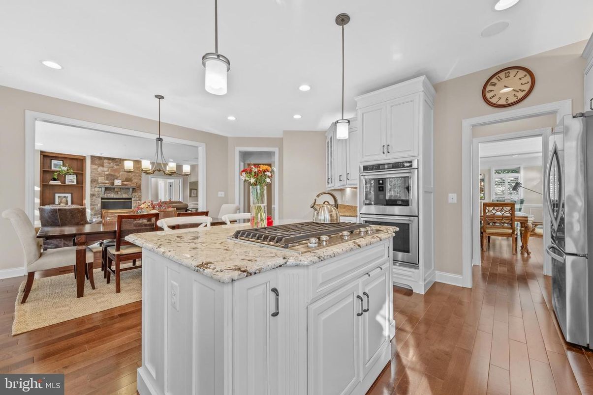 Chandelier, Dining room, Fireplace, Interior, Kitchen, Pendant Lights, Recessed Lighting, Stainless Steel Appliances, Wood Texture Flooring