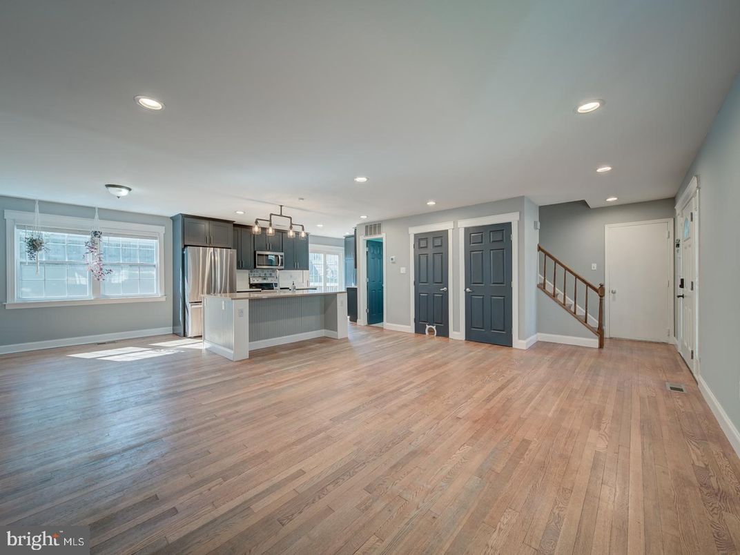 Empty room, Interior, Kitchen, Pendant Lights, Recessed Lighting, Stainless Steel Appliances, Wood Texture Flooring