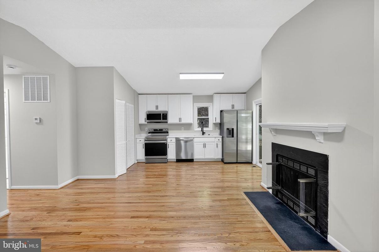 Fireplace, Interior, Kitchen, Recessed Lighting, Stainless Steel Appliances, Wood Texture Flooring