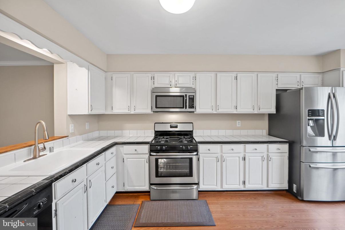 Interior, Kitchen, Stainless Steel Appliances, Tile Countertops, Wood Texture Flooring