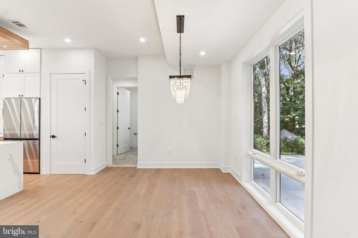 Chandelier, Empty room, Interior, Kitchen, Pendant Lights, Recessed Lighting, Stainless Steel Appliances, Wood Texture Flooring