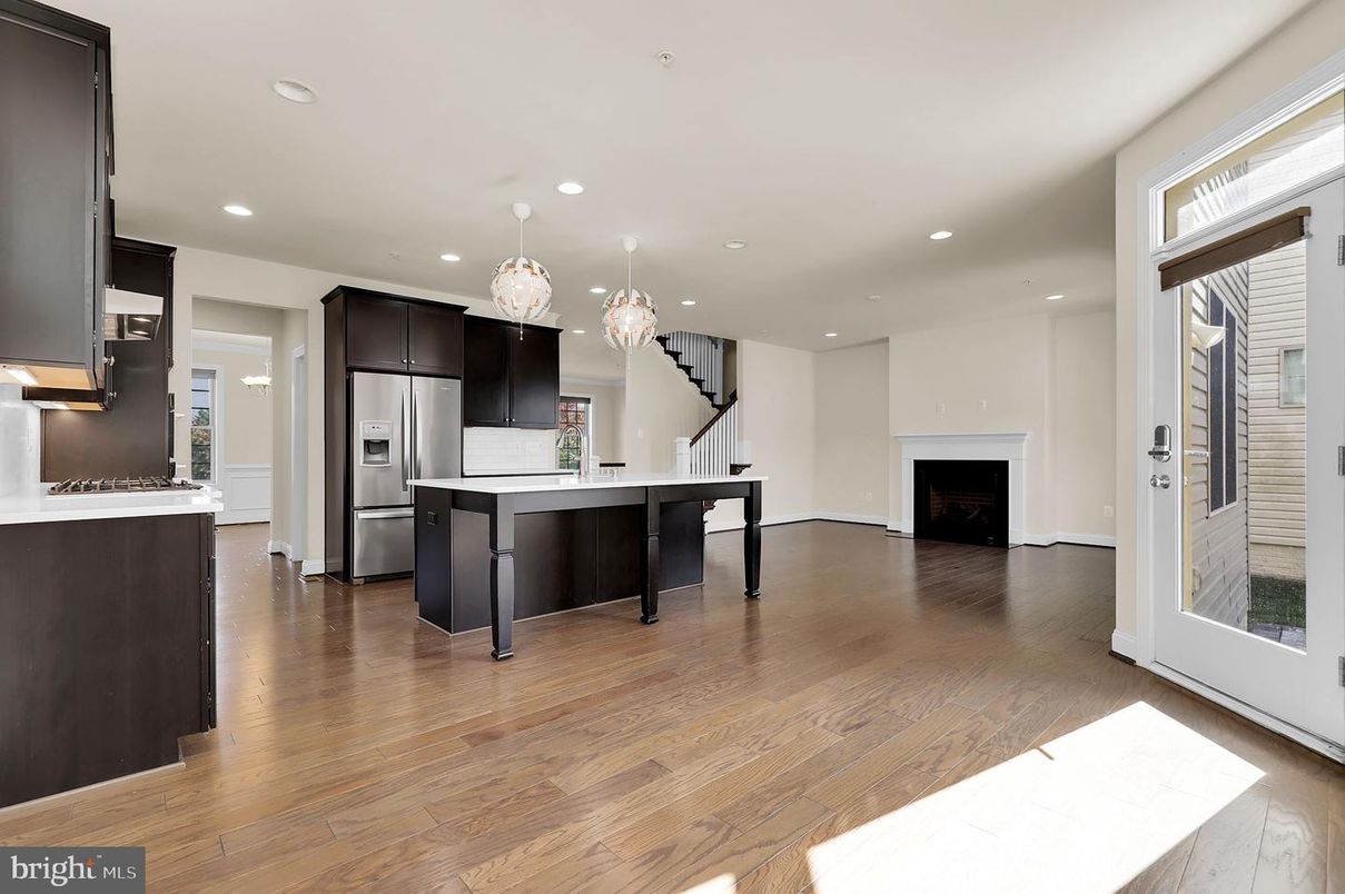 Chandelier, Fireplace, Interior, Kitchen, Pendant Lights, Recessed Lighting, Stainless Steel Appliances, Wood Texture Flooring