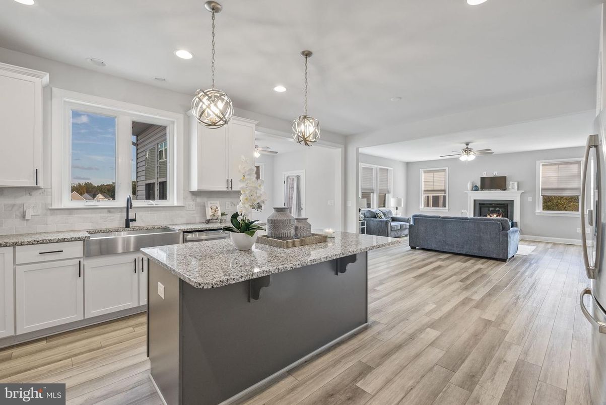 Fireplace, Interior, Kitchen, Living room, Pendant Lights, Recessed Lighting, Stainless Steel Appliances, Wood Texture Flooring