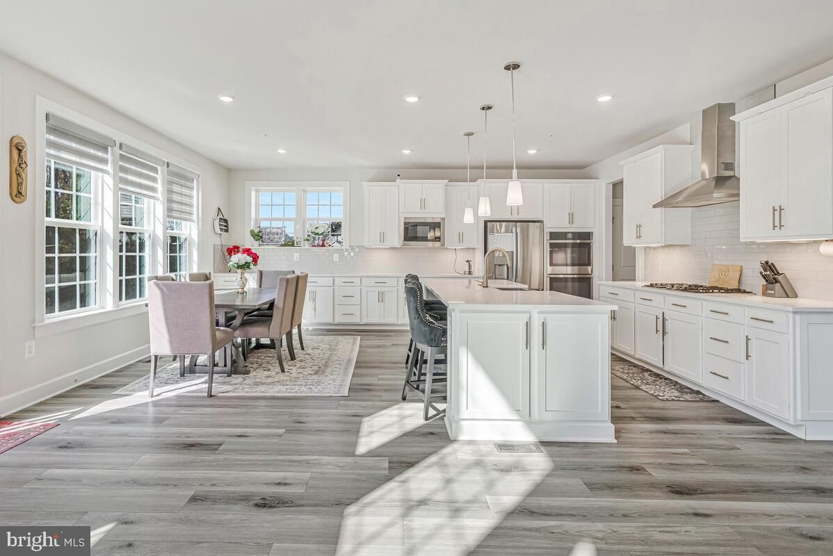 Dining room, Interior, Kitchen, Pendant Lights, Recessed Lighting, Stainless Steel Appliances, Wood Texture Flooring