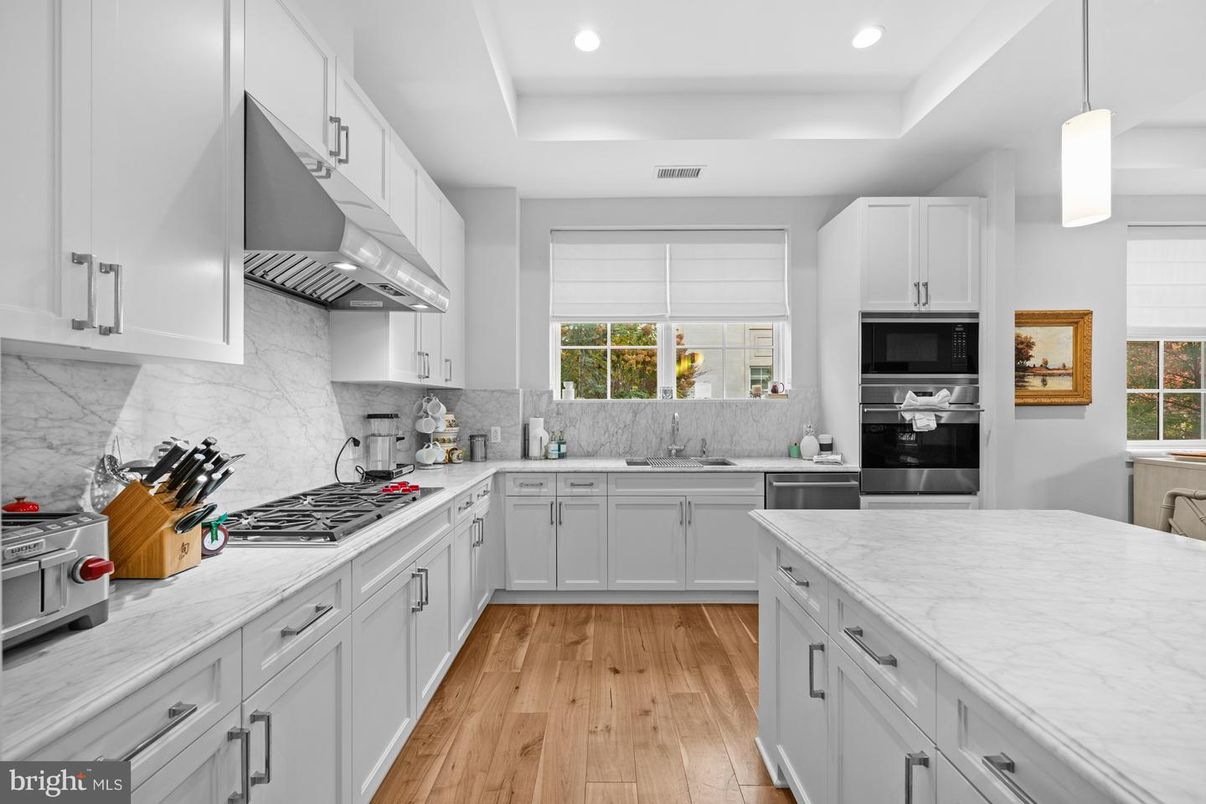 Interior, Kitchen, Marble Walls, Pendant Lights, Recessed Lighting, Stainless Steel Appliances, Wood Texture Flooring