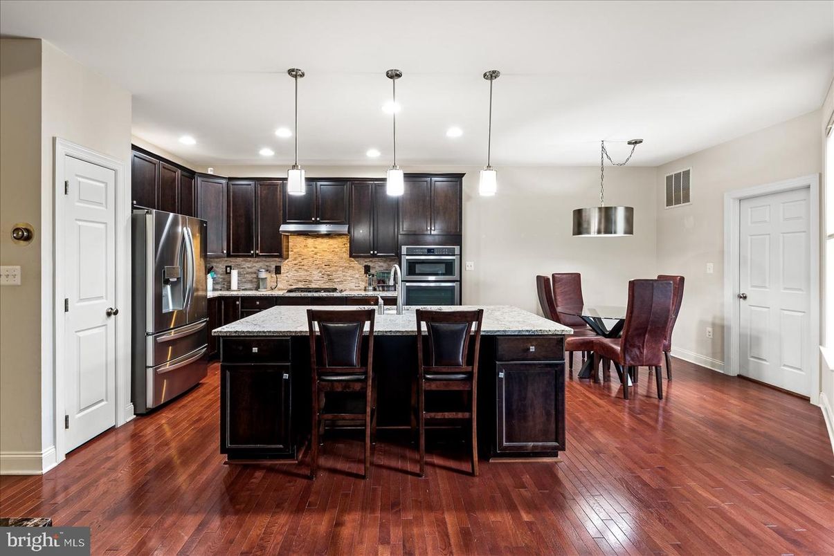 Dining room, Interior, Kitchen, Pendant Lights, Recessed Lighting, Stainless Steel Appliances, Wood Texture Flooring