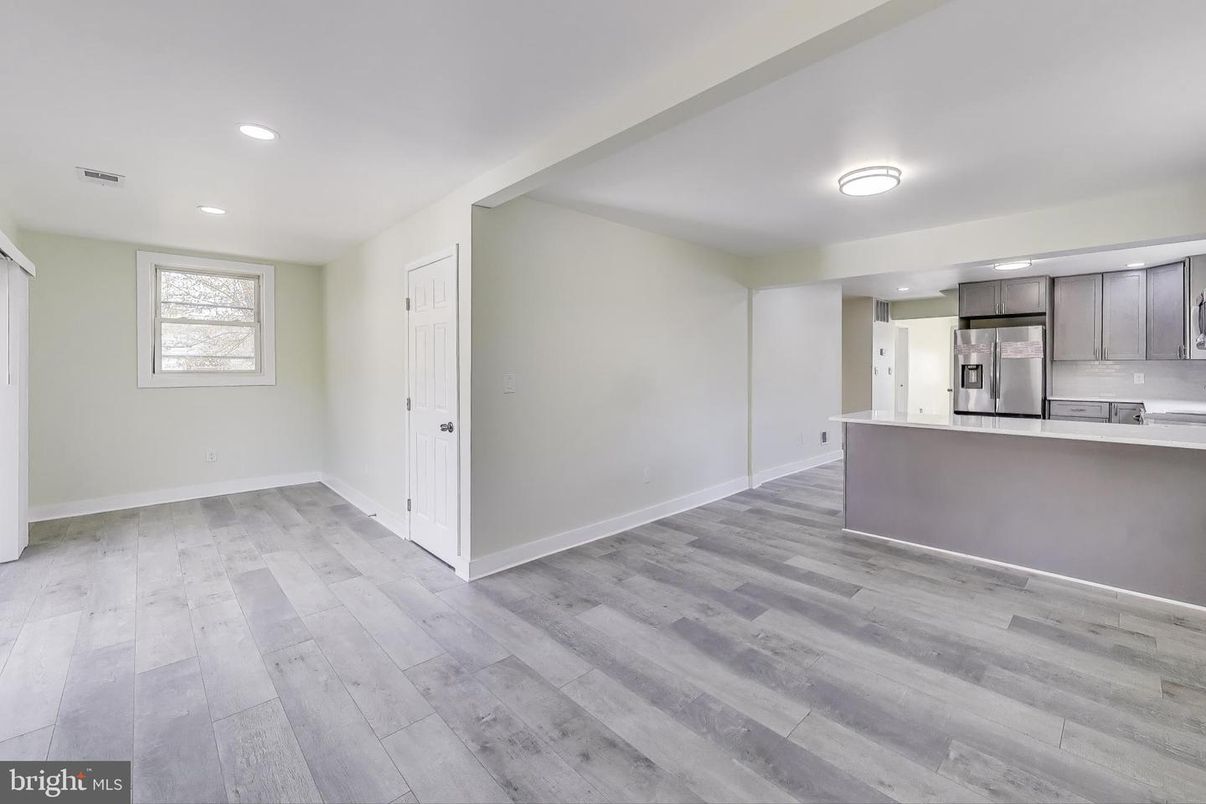 Empty room, Interior, Kitchen, Recessed Lighting, Stainless Steel Appliances, Wood Texture Flooring