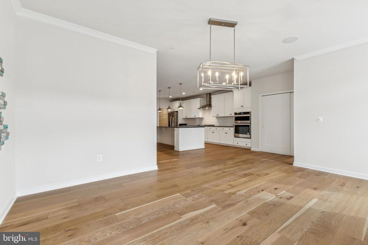 Empty room, Interior, Kitchen, Pendant Lights, Recessed Lighting, Stainless Steel Appliances, Wood Texture Flooring