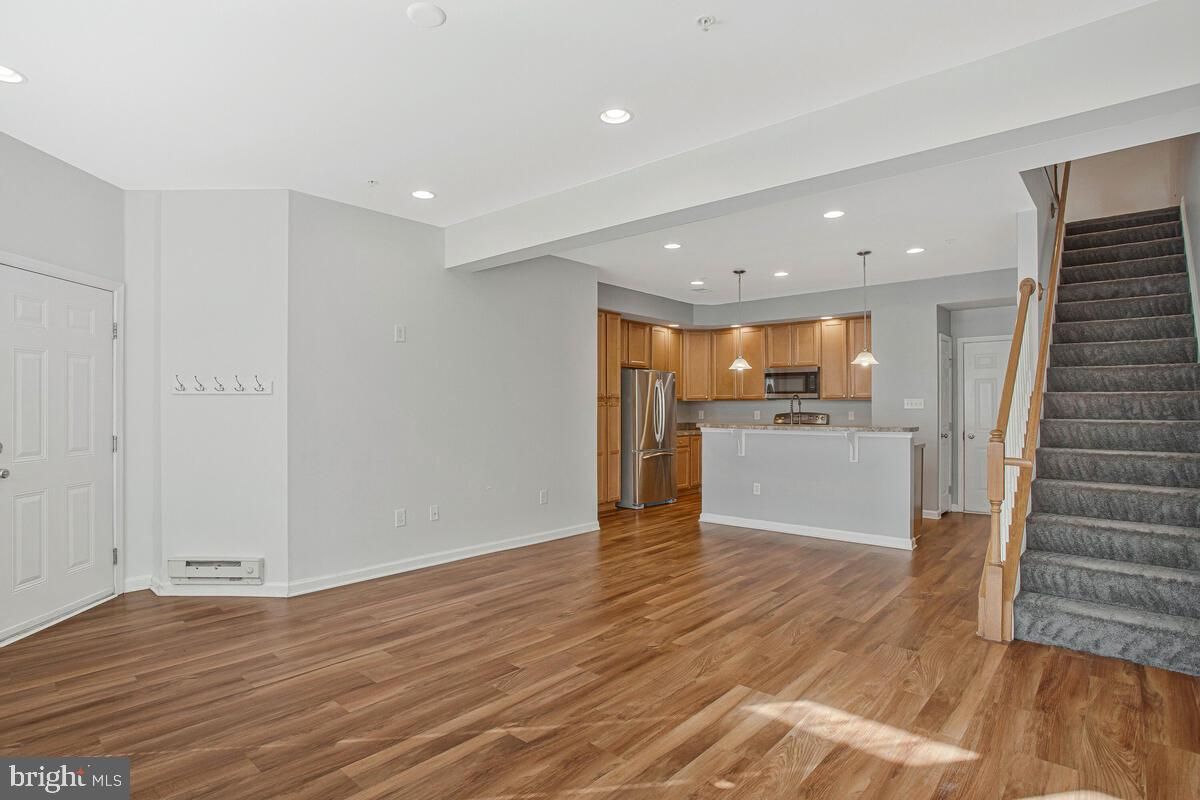 Empty room, Interior, Kitchen, Pendant Lights, Recessed Lighting, Stainless Steel Appliances, Wood Texture Flooring
