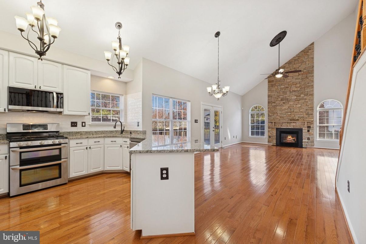 Chandelier, Empty room, Fireplace, Interior, Kitchen, Pendant Lights, Stone Walls, Wood Texture Flooring