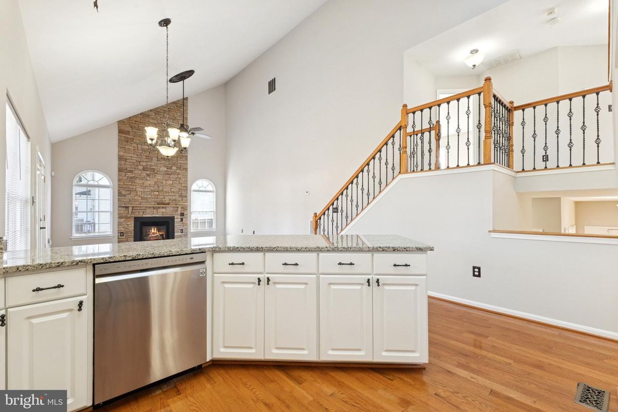 Chandelier, Fireplace, Interior, Kitchen, Pendant Lights, Stone Walls, Wood Texture Flooring