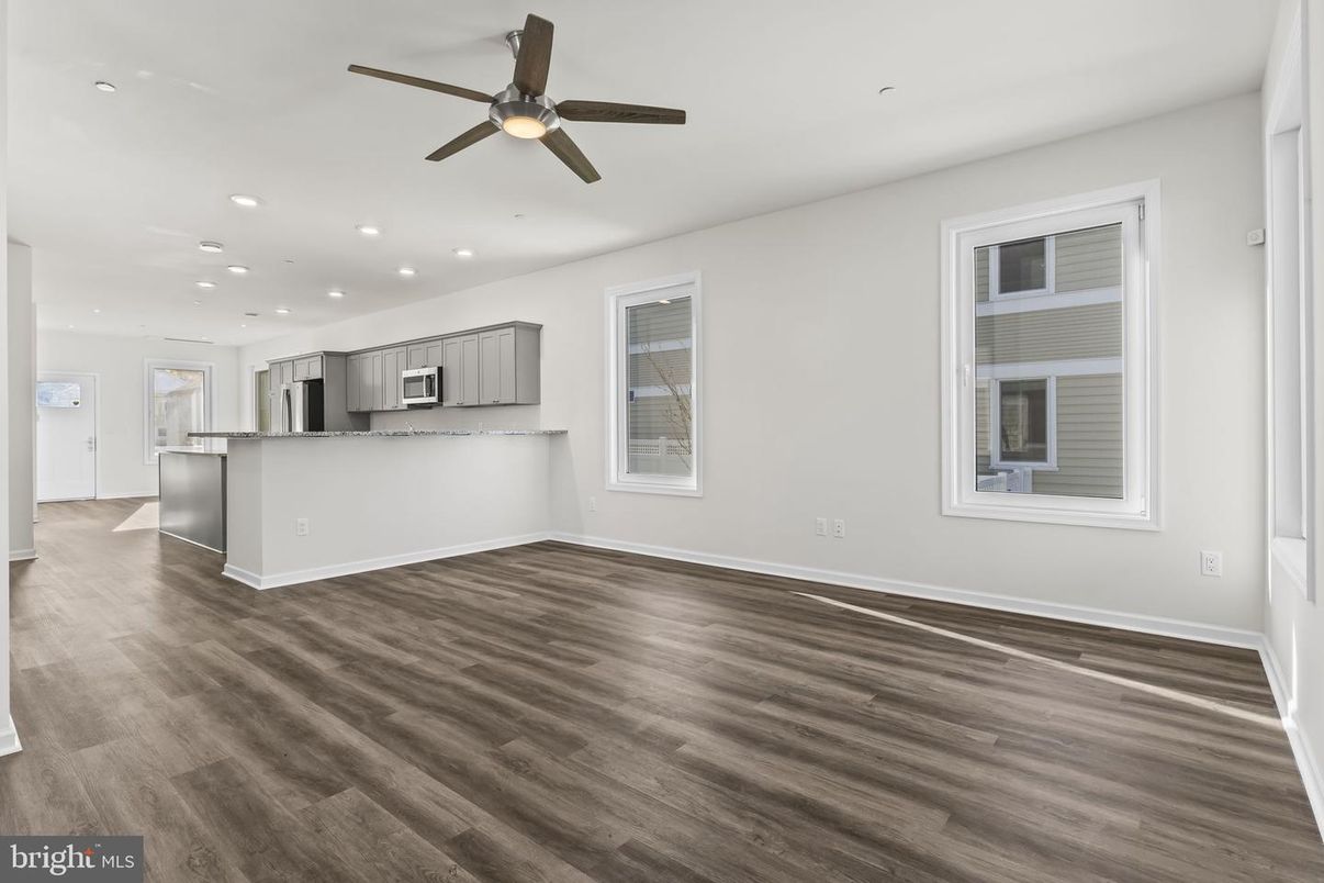 Empty room, Interior, Kitchen, Recessed Lighting, Stainless Steel Appliances, Wood Texture Flooring